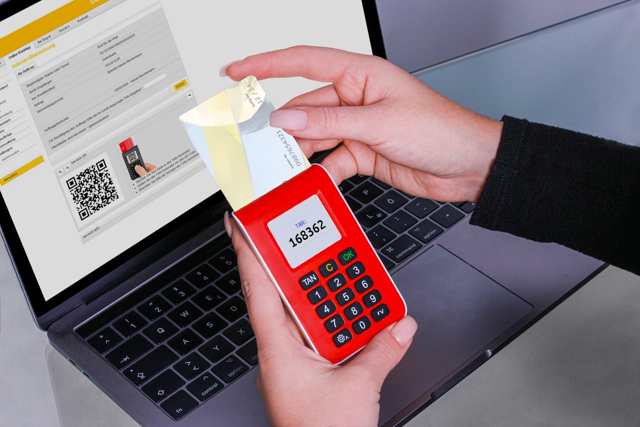 about-us-01 Woman using TAN generator for secure online payment on laptop, enhancing cybersecurity.